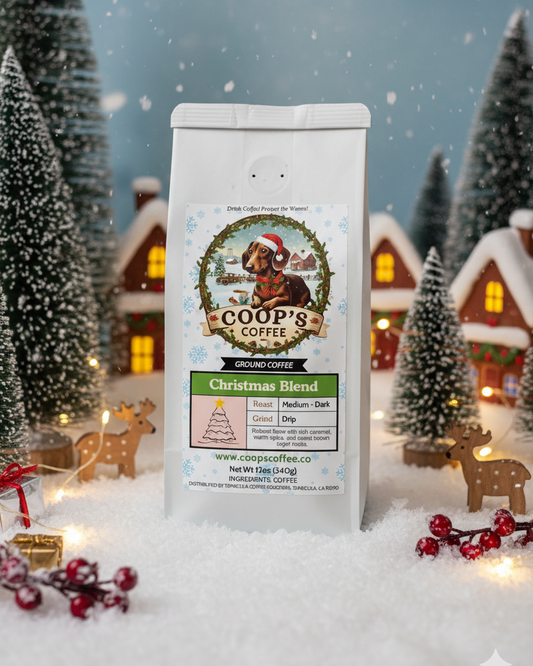 Coop's Coffee Christmas Blend package in a snowy village scene with trees and houses.